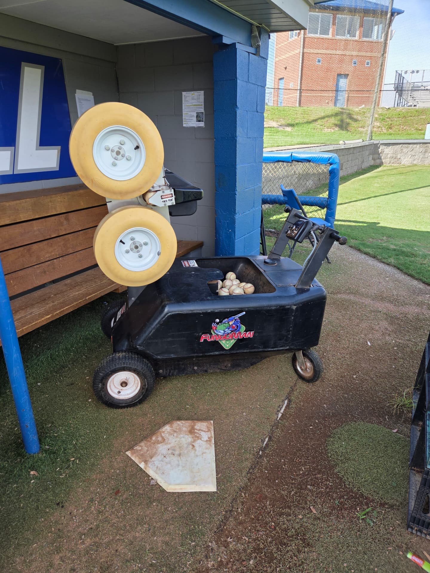 FungoMan fielding machine parked in a dugout