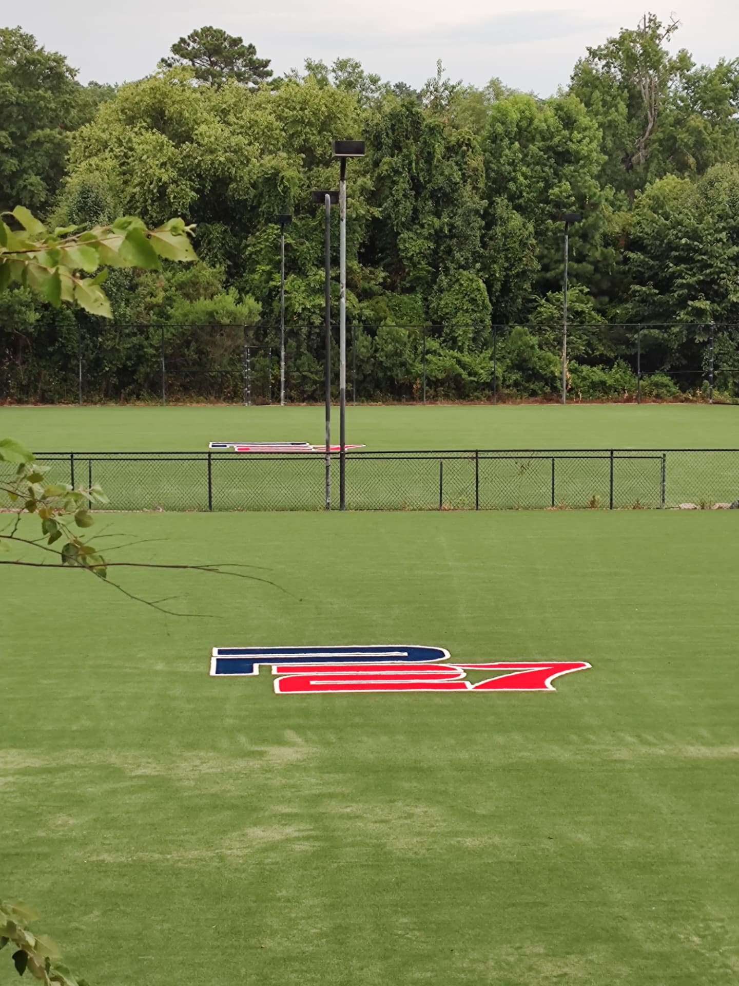 Outdoor baseball training field with P27 Baseball Academy logo on turf